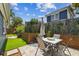 Landscaped backyard patio featuring a dining table, decorative privacy screens, and artificial turf for easy maintenance at 2807 N Morgan St, Tampa, FL 33602