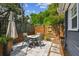 Cozy backyard patio with a dining table, modern fencing, and artificial turf, perfect for outdoor entertaining at 2807 N Morgan St, Tampa, FL 33602