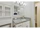 Bathroom featuring modern fixtures, granite vanity top, mirror, and stylish decor next to laundry at 2807 N Morgan St, Tampa, FL 33602
