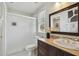 Bathroom features a dark vanity, a walk-in shower, and bright natural light at 2807 N Morgan St, Tampa, FL 33602