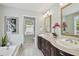 Bright bathroom features a double vanity, jacuzzi tub, and a window for natural light at 2807 N Morgan St, Tampa, FL 33602