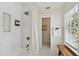Updated bathroom with white tiled shower, bronze fixtures, and hexagonal floor tiling at 2807 N Morgan St, Tampa, FL 33602