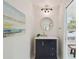 Bathroom showcasing a vanity with gold accents, a round mirror, and bright lighting at 2807 N Morgan St, Tampa, FL 33602