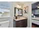 Bathroom with a dark vanity, framed mirror, and a view into the bedroom at 2807 N Morgan St, Tampa, FL 33602