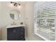 Bathroom features a modern vanity with gold fixtures and lots of natural light at 2807 N Morgan St, Tampa, FL 33602