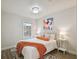 Cozy bedroom with a queen bed, wood floors, a colorful piece of art, and side tables with lamps at 2807 N Morgan St, Tampa, FL 33602
