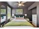 Well-lit bedroom featuring a large bed, two windows, and sleek, dark-toned walls at 2807 N Morgan St, Tampa, FL 33602