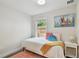 Bright bedroom with a single bed, wood floors, colorful rug, and a painting of sail boats at 2807 N Morgan St, Tampa, FL 33602