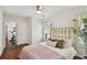 Bedroom features a brass bed frame, ceiling fan, and a light and airy aesthetic at 2807 N Morgan St, Tampa, FL 33602