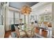 Elegant dining room features a modern chandelier, hardwood floors, and ample natural light at 2807 N Morgan St, Tampa, FL 33602