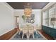Bright dining room with hardwood floors and a unique chandelier, perfect for entertaining guests at 2807 N Morgan St, Tampa, FL 33602