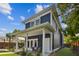 Stylish two-story house with blue siding, white trim, covered porch, and a beautifully landscaped yard at 2807 N Morgan St, Tampa, FL 33602