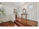 Inviting foyer with hardwood floors, decorative mirror, and a stairway leading to the upper level at 2807 N Morgan St, Tampa, FL 33602