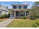 Charming two-story home featuring a covered front porch with seating and manicured landscaping at 2807 N Morgan St, Tampa, FL 33602