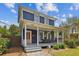 Charming two-story home featuring a covered front porch with seating and manicured landscaping at 2807 N Morgan St, Tampa, FL 33602