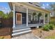 Inviting covered front porch featuring comfortable seating, hanging plants, and classic architectural details at 2807 N Morgan St, Tampa, FL 33602