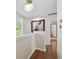 Hallway with hardwood floors, a thermostat, and natural light from a window at 2807 N Morgan St, Tampa, FL 33602