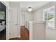Hallway with wood flooring, window, and neutral walls, creating a bright and open space at 2807 N Morgan St, Tampa, FL 33602