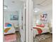 Hallway shot of two bedrooms, one with twin bed, one with queen bed, and wood floors at 2807 N Morgan St, Tampa, FL 33602