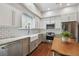 Modern kitchen features stainless steel appliances, white cabinets, granite countertops, and farmhouse sink at 2807 N Morgan St, Tampa, FL 33602
