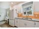 Modern kitchen with white cabinets, stainless steel appliances, granite countertops, and an adjoining dinette area at 2807 N Morgan St, Tampa, FL 33602