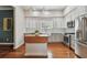 Bright, modern kitchen with stainless steel appliances, farmhouse sink, white cabinets, and hardwood floors at 2807 N Morgan St, Tampa, FL 33602