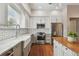 Modern kitchen features stainless steel appliances, a farmhouse sink, granite countertops and a center island at 2807 N Morgan St, Tampa, FL 33602