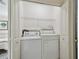 Laundry closet with side by side washer and dryer and wire rack shelving at 2807 N Morgan St, Tampa, FL 33602