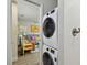 Modern laundry room with stacked washer and dryer, with a partial view into a colorful living room space at 2807 N Morgan St, Tampa, FL 33602