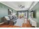 Spacious living room boasts dark green walls, a leather couch and access to a patio at 2807 N Morgan St, Tampa, FL 33602