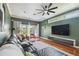 Inviting living room with dark green walls, hardwood floors, and large windows at 2807 N Morgan St, Tampa, FL 33602
