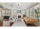 Open living room features hardwood flooring, a decorative fireplace, and modern light fixtures at 2807 N Morgan St, Tampa, FL 33602