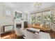 Bright living room featuring a decorative fireplace, hardwood floors, and large windows at 2807 N Morgan St, Tampa, FL 33602
