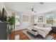 Sunlit main bedroom with hardwood flooring, a ceiling fan, and decor at 2807 N Morgan St, Tampa, FL 33602