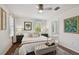 Tranquil main bedroom with hardwood floors, a ceiling fan, and an ensuite bathroom at 2807 N Morgan St, Tampa, FL 33602