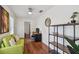 Cozy home office with a modern desk, green futon, and ample shelving for organization at 2807 N Morgan St, Tampa, FL 33602
