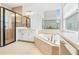 Bathroom featuring soaking tub, walk-in shower, and tile flooring at 30900 Spruceberry Ct, Wesley Chapel, FL 33543