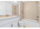 Bright, white bathroom with shower and tub combination and large vanity at 30900 Spruceberry Ct, Wesley Chapel, FL 33543