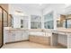 Bathroom featuring soaking tub, walk-in shower, and double vanity at 30900 Spruceberry Ct, Wesley Chapel, FL 33543