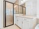 Bathroom with tile flooring, walk-in shower, and white vanity at 30900 Spruceberry Ct, Wesley Chapel, FL 33543