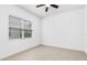 Bright bedroom features neutral floors, a window, and white walls at 30900 Spruceberry Ct, Wesley Chapel, FL 33543
