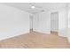 Bedroom with wood-look flooring, ceiling fan and walk-in closet at 30900 Spruceberry Ct, Wesley Chapel, FL 33543