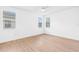 Bright bedroom with hardwood floors, ceiling fan, and windows with blinds at 30900 Spruceberry Ct, Wesley Chapel, FL 33543