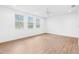 Bright bedroom featuring hardwood floors, white walls, and natural light at 30900 Spruceberry Ct, Wesley Chapel, FL 33543