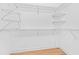 Spacious walk-in closet with white walls, wood floors, and wire shelving for organization at 30900 Spruceberry Ct, Wesley Chapel, FL 33543