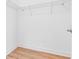 Walk-in closet with wire shelving and wood-look flooring at 30900 Spruceberry Ct, Wesley Chapel, FL 33543