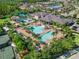Aerial view of resort-style community pools and a splash zone with various water features and amenities at 30900 Spruceberry Ct, Wesley Chapel, FL 33543