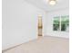 Dining room featuring neutral tile flooring, and a large window overlooking the landscaped outdoors at 30900 Spruceberry Ct, Wesley Chapel, FL 33543