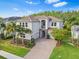 Stunning two-story home featuring a tile roof, a brick paver driveway and lush landscaping at 30900 Spruceberry Ct, Wesley Chapel, FL 33543