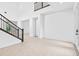 Bright, spacious foyer with tiled flooring and a staircase with dark wood accents at 30900 Spruceberry Ct, Wesley Chapel, FL 33543